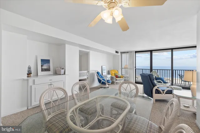 a living room with furniture a flat screen tv and a large window