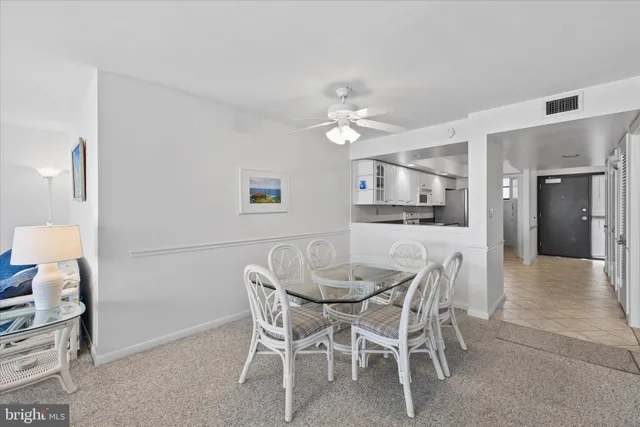 a view of a dining room with furniture and a chandelier