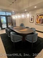 a kitchen with stainless steel appliances a table and chairs in it