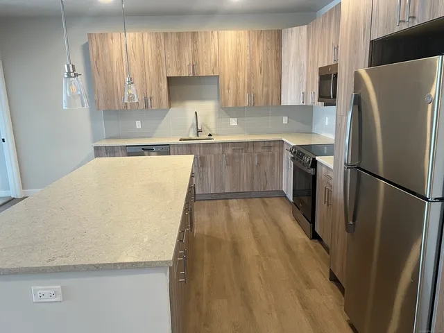 a kitchen with a refrigerator a sink and a stove
