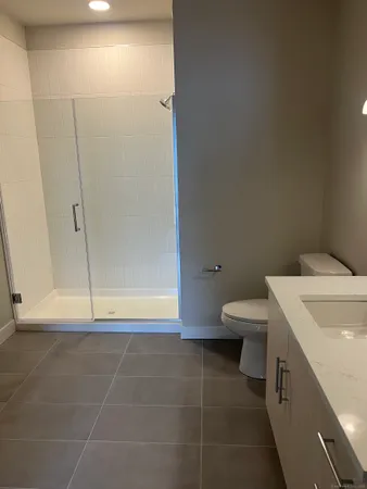 a bathroom with a toilet and a shower