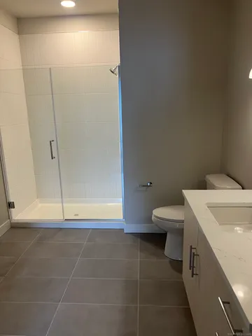 a bathroom with a toilet and a shower