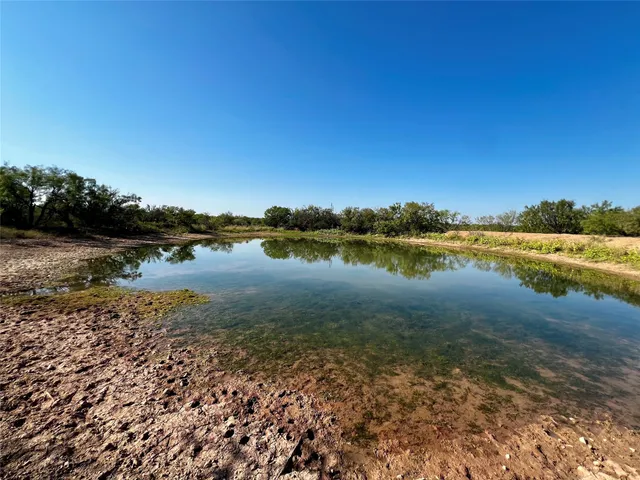 a view of a lake with houses in the background