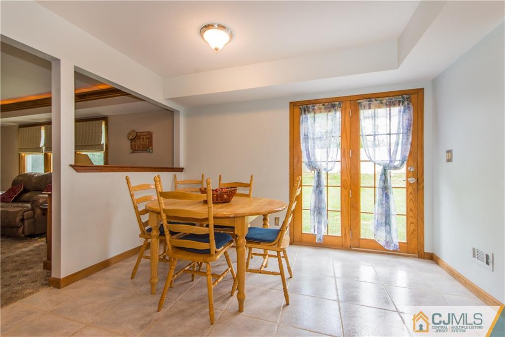 48 Roxy Avenue Edison, NJ 08820 - Photo 11 of 32 a view of a dining room with furniture and a large window