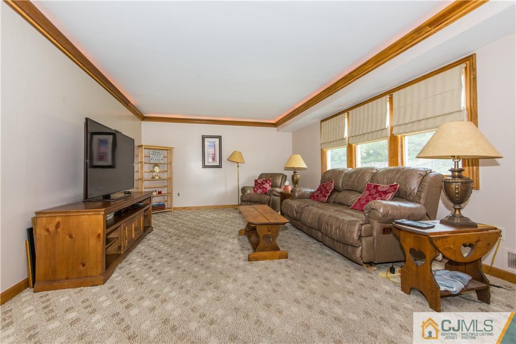48 Roxy Avenue Edison, NJ 08820 - Photo 12 of 32 a living room with furniture and a flat screen tv