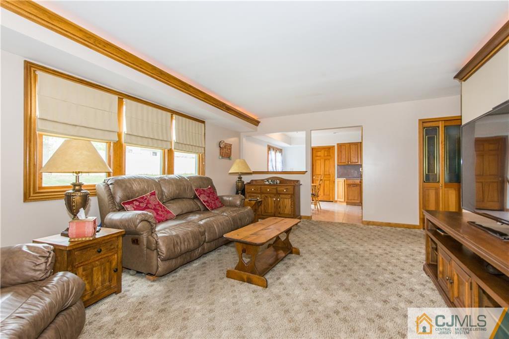 48 Roxy Avenue Edison, NJ 08820 - Photo 13 of 32 a living room with furniture and a flat screen tv