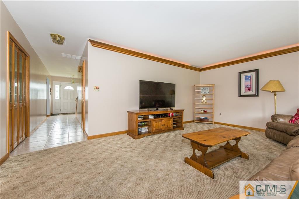 48 Roxy Avenue Edison, NJ 08820 - Photo 14 of 32 a living room with furniture and a flat screen tv