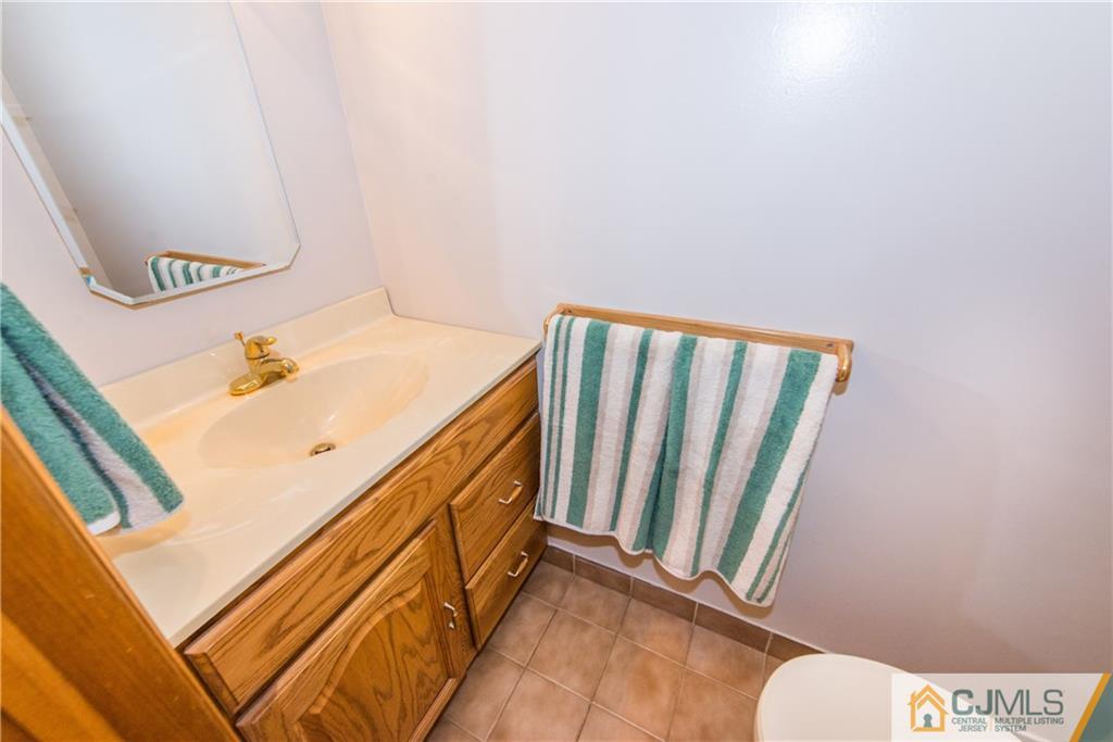 48 Roxy Avenue Edison, NJ 08820 - Photo 17 of 32 a bathroom with a sink and mirror