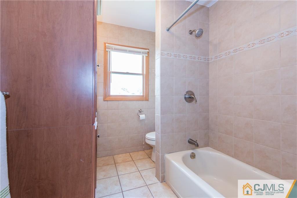 48 Roxy Avenue Edison, NJ 08820 - Photo 21 of 32 a bathroom with a bathtub shower and toilet