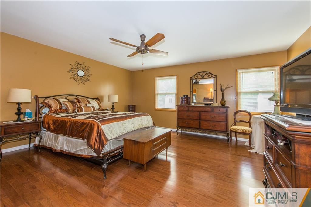 48 Roxy Avenue Edison, NJ 08820 - Photo 26 of 32 a bedroom with a bed and a chandelier
