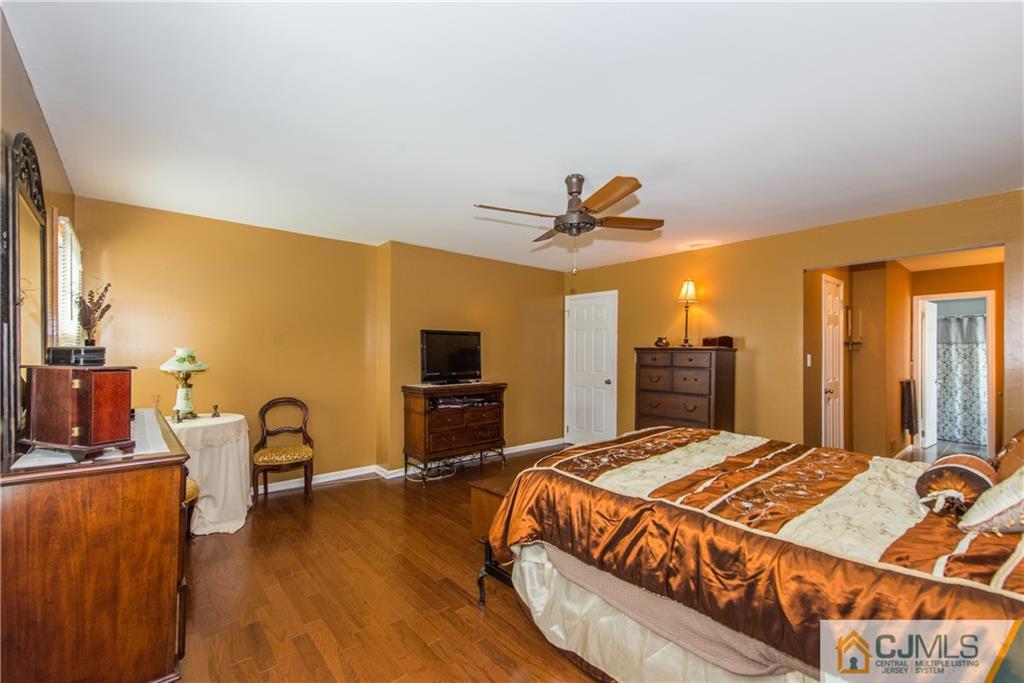 48 Roxy Avenue Edison, NJ 08820 - Photo 27 of 32 a bedroom with a bed and wooden floor