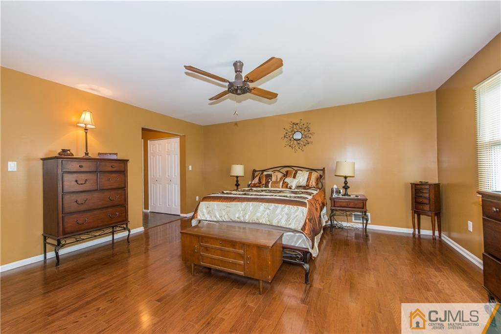 48 Roxy Avenue Edison, NJ 08820 - Photo 28 of 32 a spacious bedroom with a bed and wooden floor