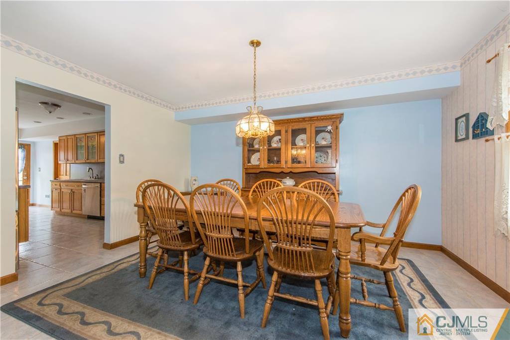 48 Roxy Avenue Edison, NJ 08820 - Photo 4 of 32 a dining room with furniture a chandelier and wooden floor