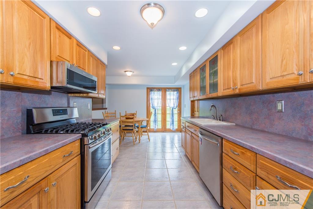 48 Roxy Avenue Edison, NJ 08820 - Photo 7 of 32 a kitchen with stainless steel appliances granite countertop a stove a sink and a microwave