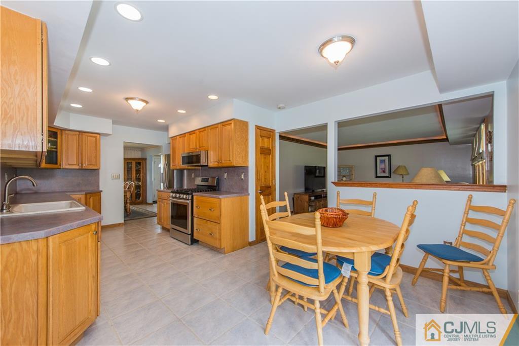 48 Roxy Avenue Edison, NJ 08820 - Photo 8 of 32 a kitchen with a table and chairs in it