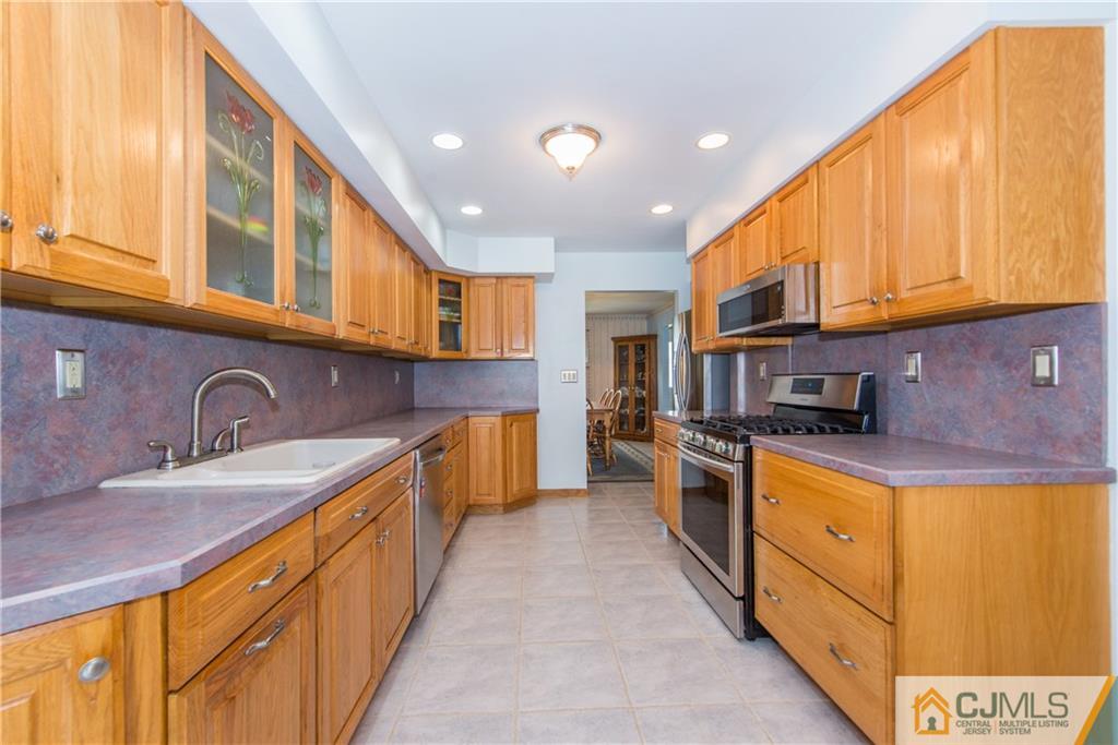 48 Roxy Avenue Edison, NJ 08820 - Photo 10 of 32 a large kitchen with stainless steel appliances granite countertop a sink a stove and cabinets