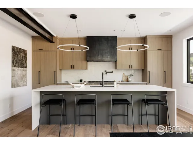 a kitchen with a sink a center island and cabinets