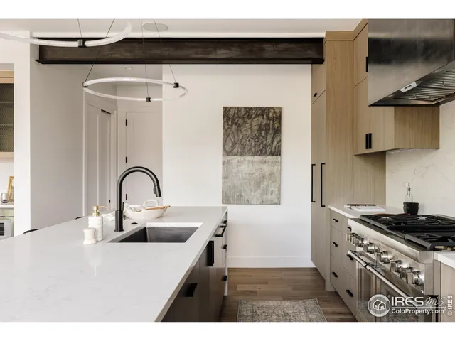a kitchen with stainless steel appliances a sink a stove and a refrigerator