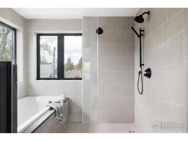 a bathroom with a bathtub and a shower