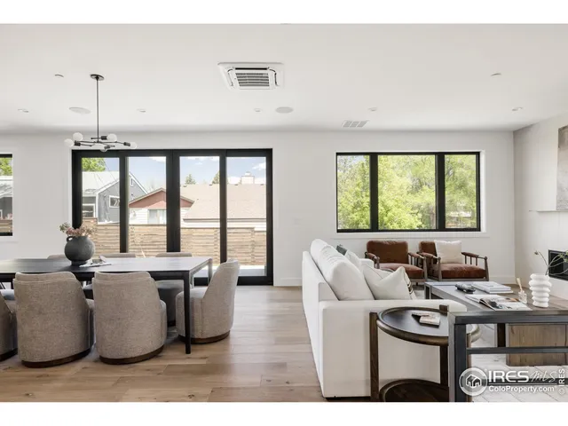 a living room with furniture a large window and a table