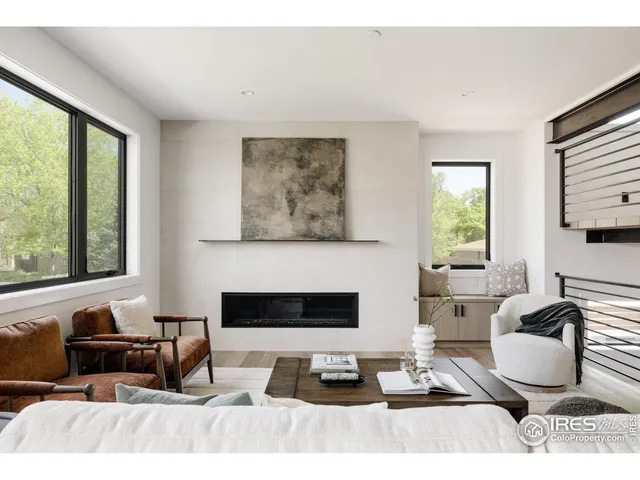 a living room with furniture a rug and a large window