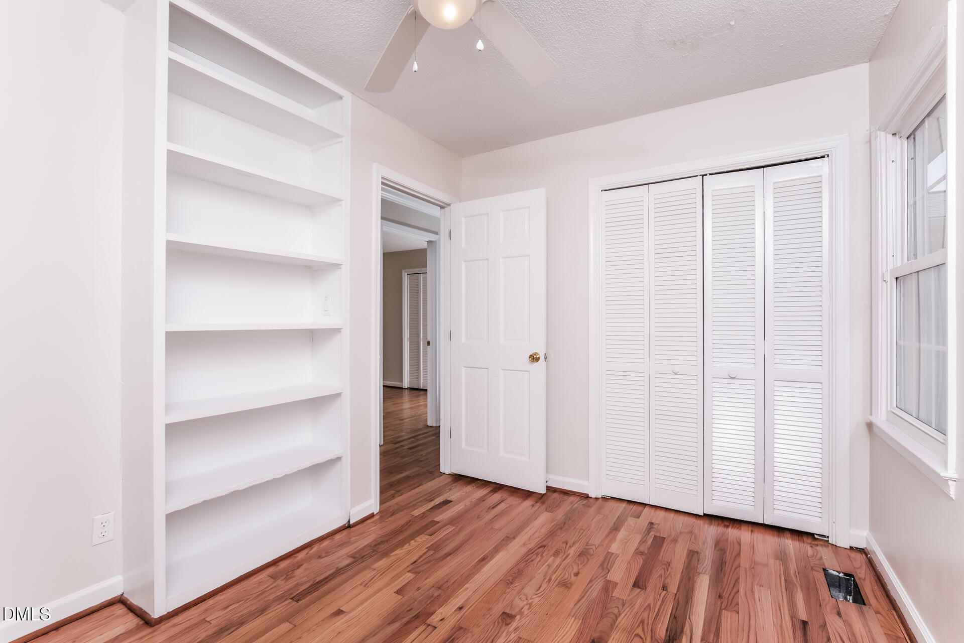 870 Abbott Road Henderson, NC 27537 - Photo 15 of 20 a view of an empty room with a window and wooden floor
