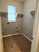 a view of a small space with wooden floor and a window