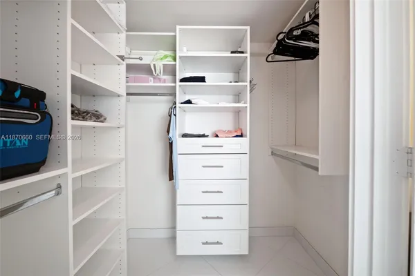 a bedroom with two beds and a window