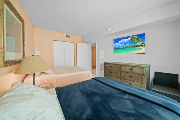 a bedroom with a bed and a lamp next to a window