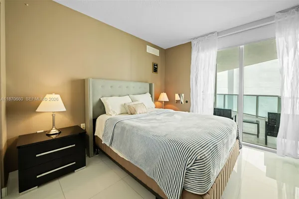 a bedroom with a bed and a lamp