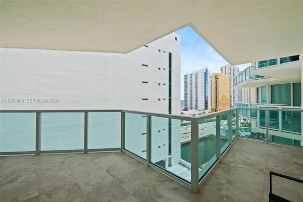 a view of a balcony with chairs and front door