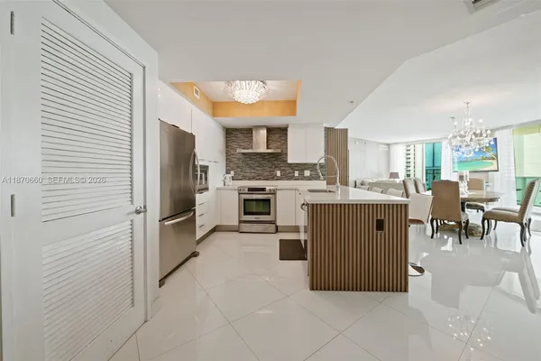 a kitchen with stainless steel appliances granite countertop a stove sink and cabinets