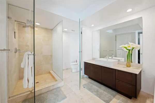 a bathroom with a tub a sink and a mirror