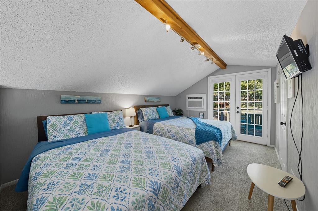 517 Shoreline Drive Tool, TX 75143 - Photo 15 of 28 a bedroom with bed and glass door