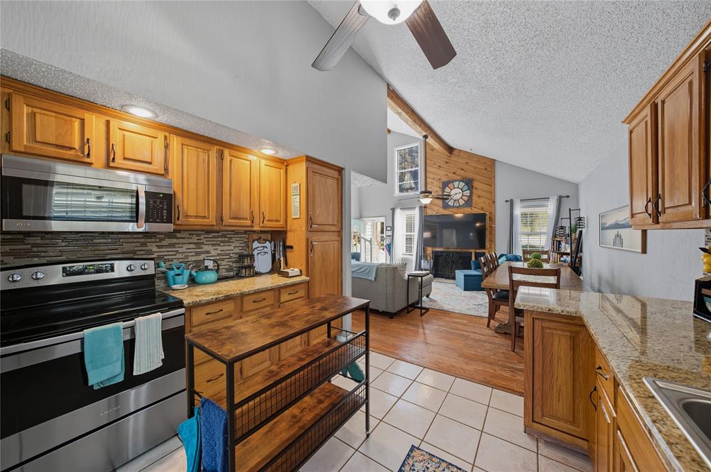 517 Shoreline Drive Tool, TX 75143 - Photo 8 of 28 a large living room with stainless steel appliances furniture a fireplace and a flat screen tv