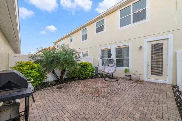 a couple of table and chairs in front of house