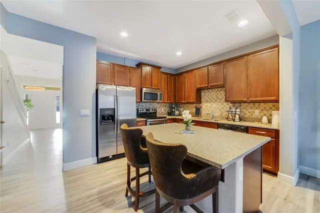 a kitchen with refrigerator and cabinets
