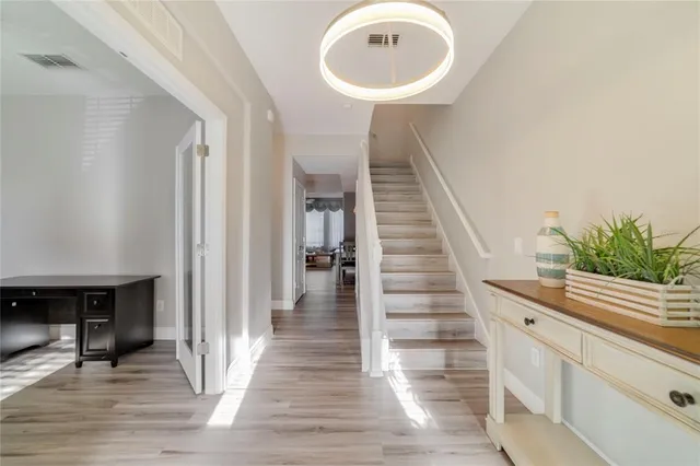 a view of entryway and hall with wooden floor
