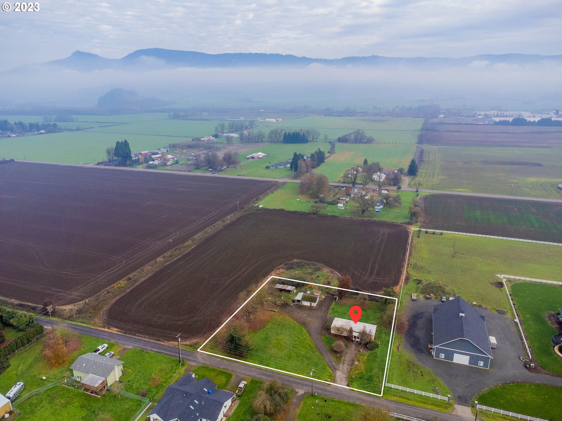 an aerial view of a house with a yard