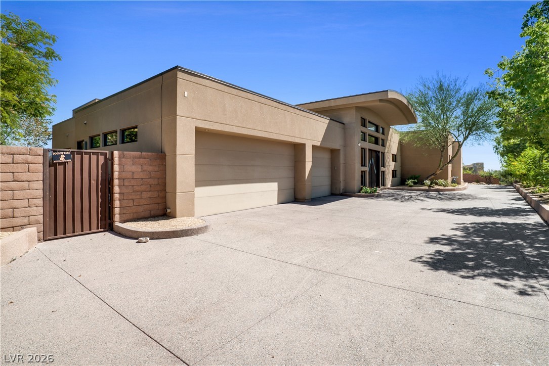 10 Ridge Blossom Road Las Vegas, NV 89135 - Photo 59 of 64 View of front of house with stucco siding, concrete driveway, and an attached garage