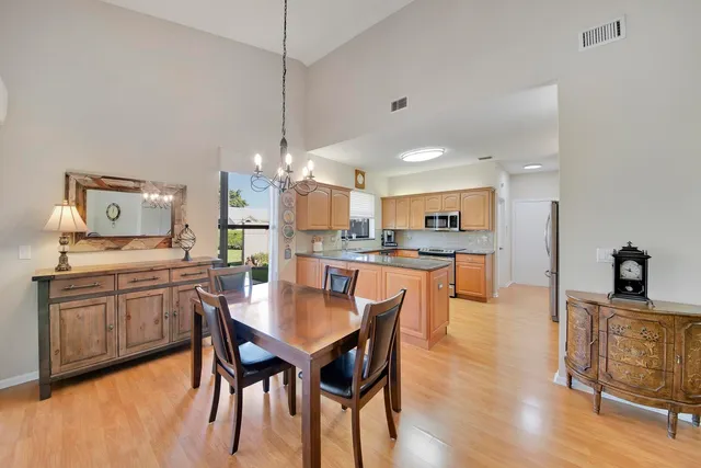 a kitchen with stainless steel appliances granite countertop a refrigerator stove and sink