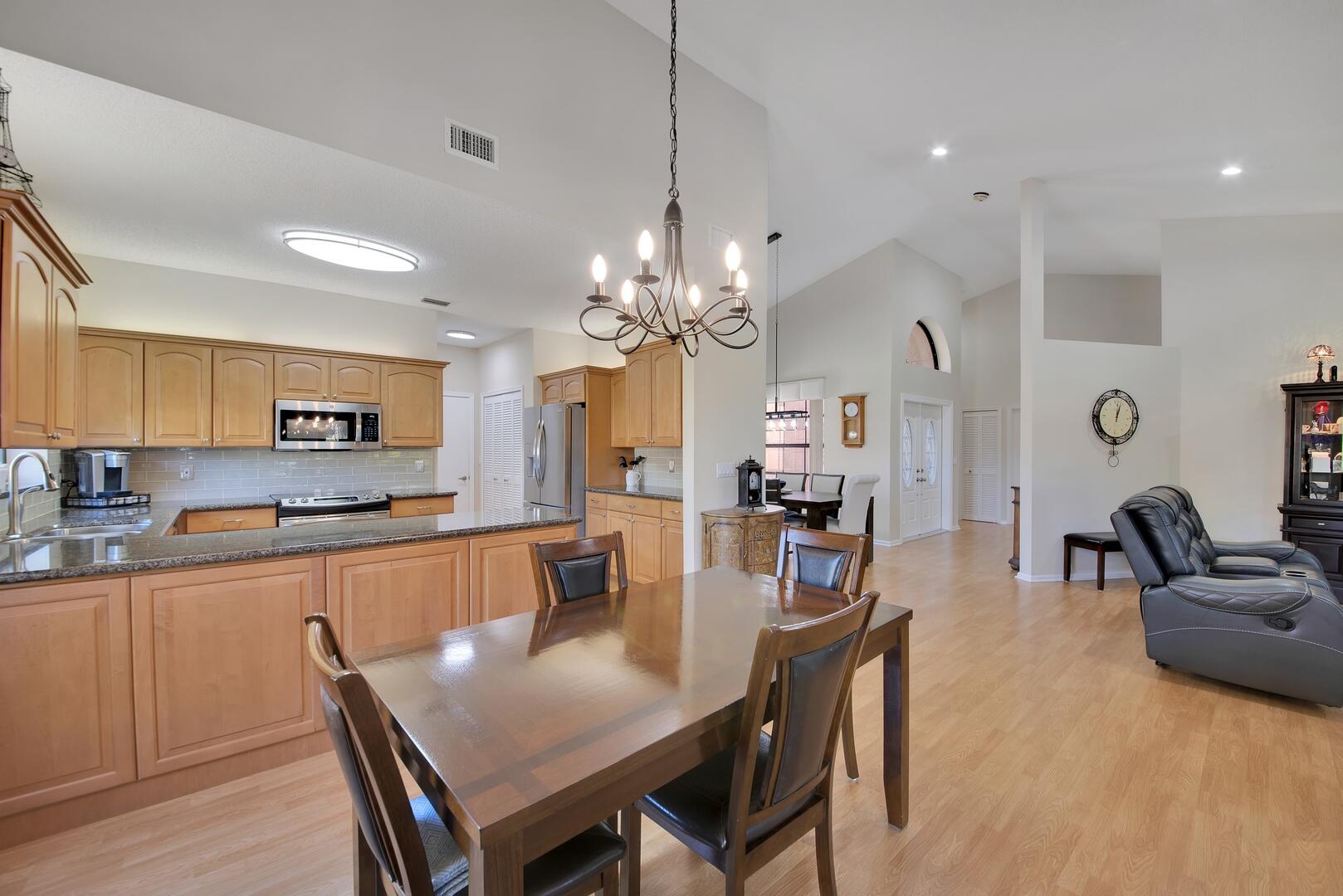 19261 Cherry Hills Terrace Boca Raton, FL 33498 - Photo 16 of 53 a large kitchen with a table and chairs