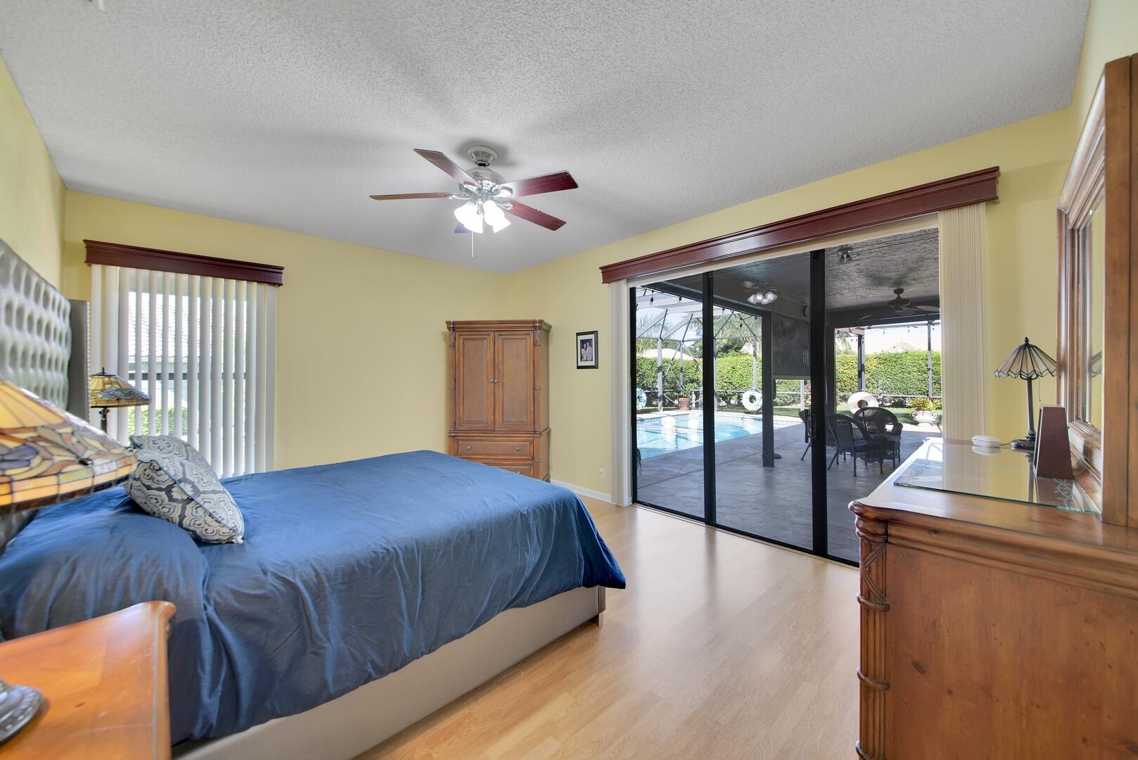 19261 Cherry Hills Terrace Boca Raton, FL 33498 - Photo 20 of 53 a bedroom with a large bed and a chandelier