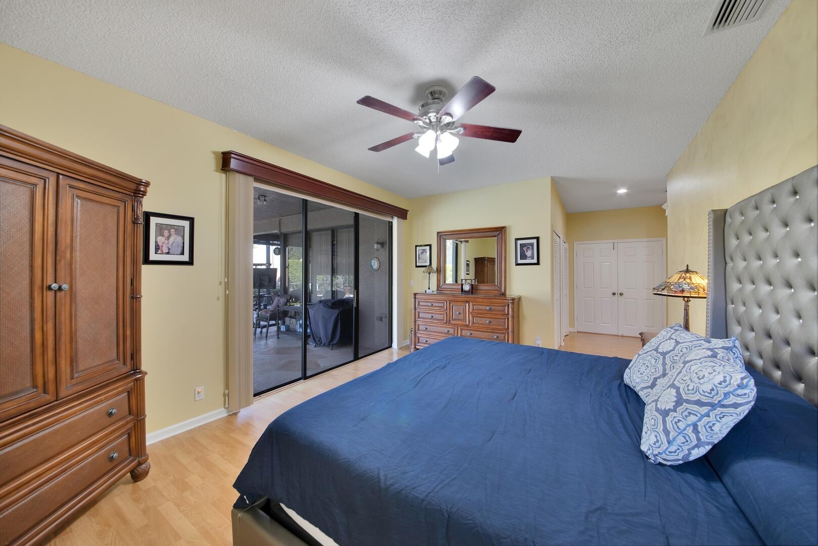 19261 Cherry Hills Terrace Boca Raton, FL 33498 - Photo 21 of 53 a bedroom with a bed and a chandelier