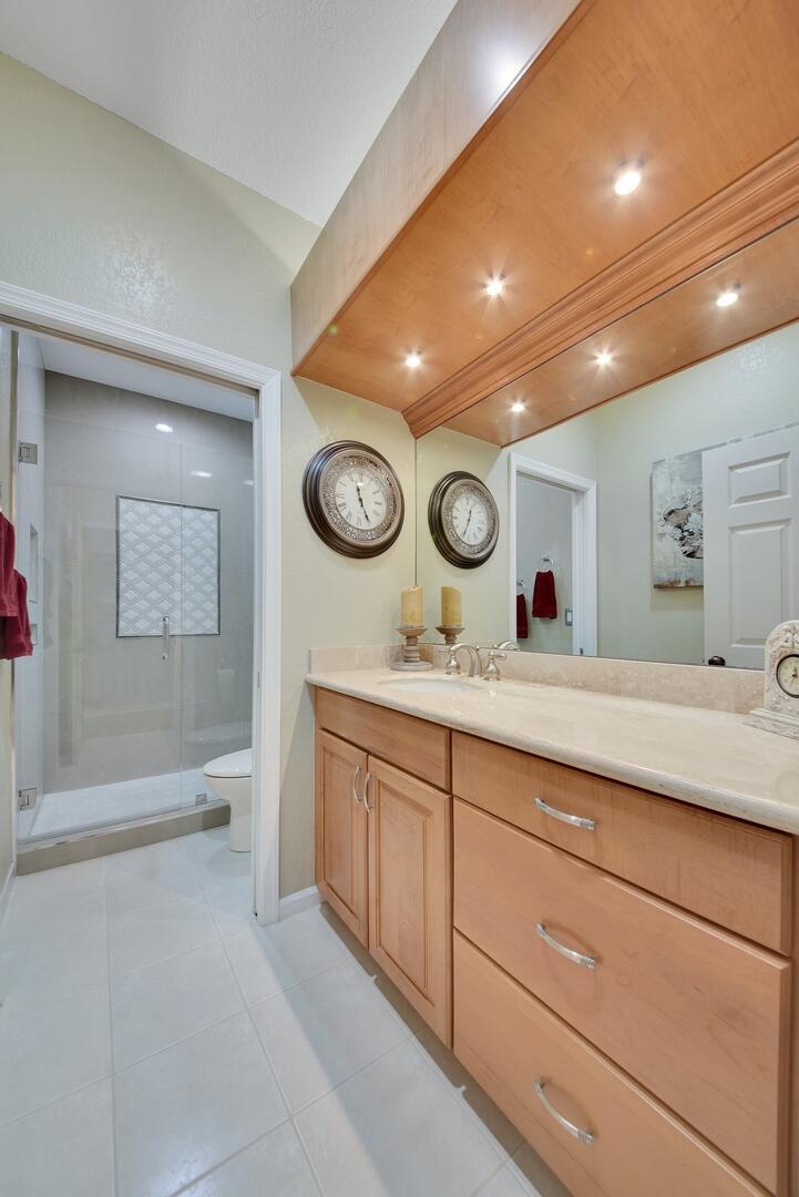 19261 Cherry Hills Terrace Boca Raton, FL 33498 - Photo 27 of 53 a bathroom with a sink and a large mirror