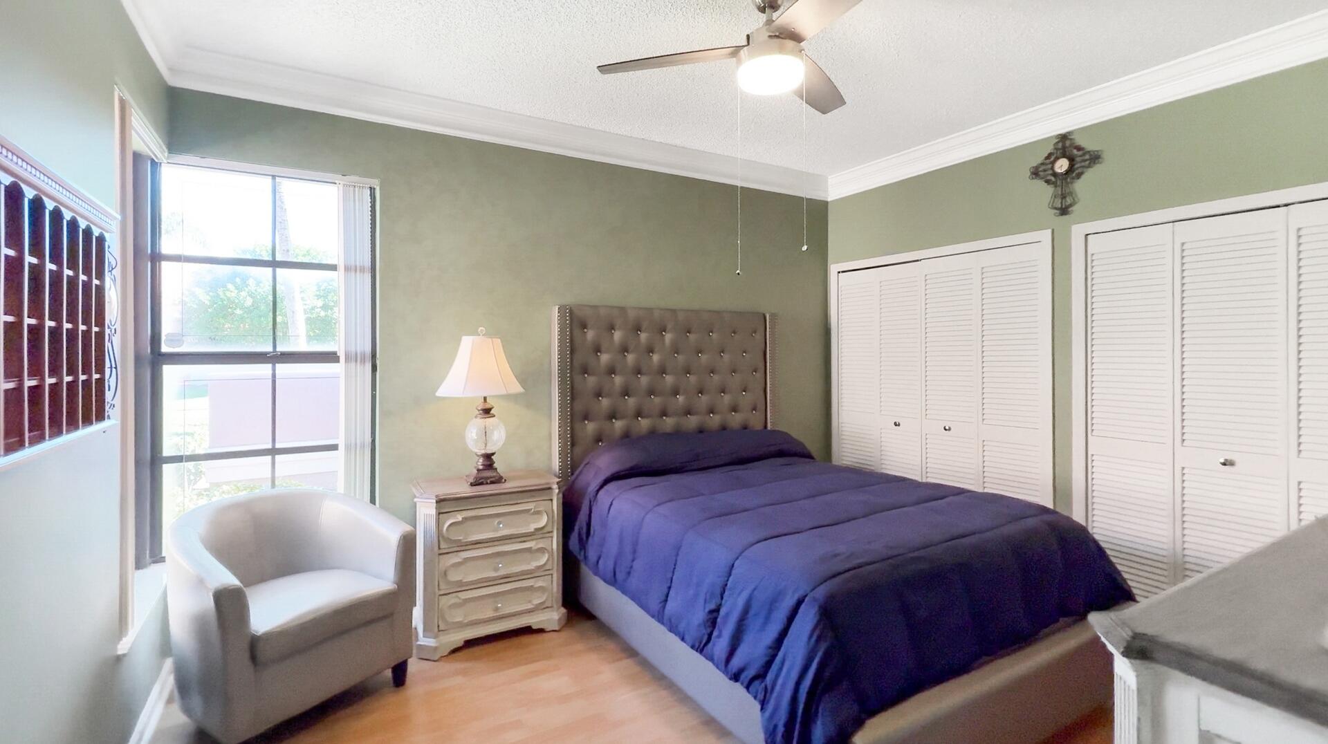 19261 Cherry Hills Terrace Boca Raton, FL 33498 - Photo 28 of 53 a bedroom with a bed and a couch