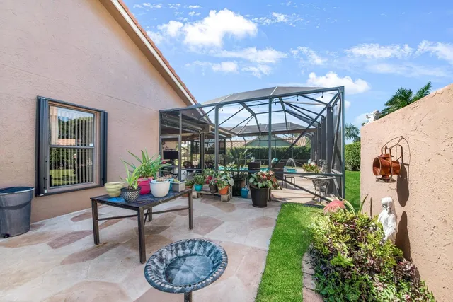 a view of a chairs and table in backyard of the house