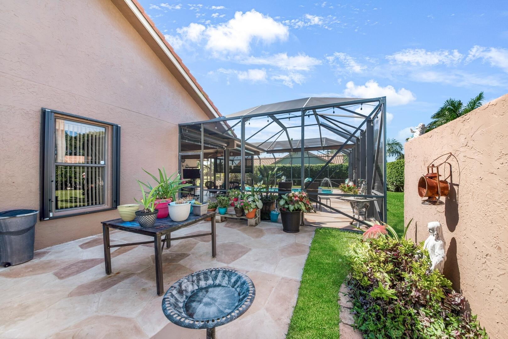 19261 Cherry Hills Terrace Boca Raton, FL 33498 - Photo 37 of 53 a view of a chairs and table in backyard of the house