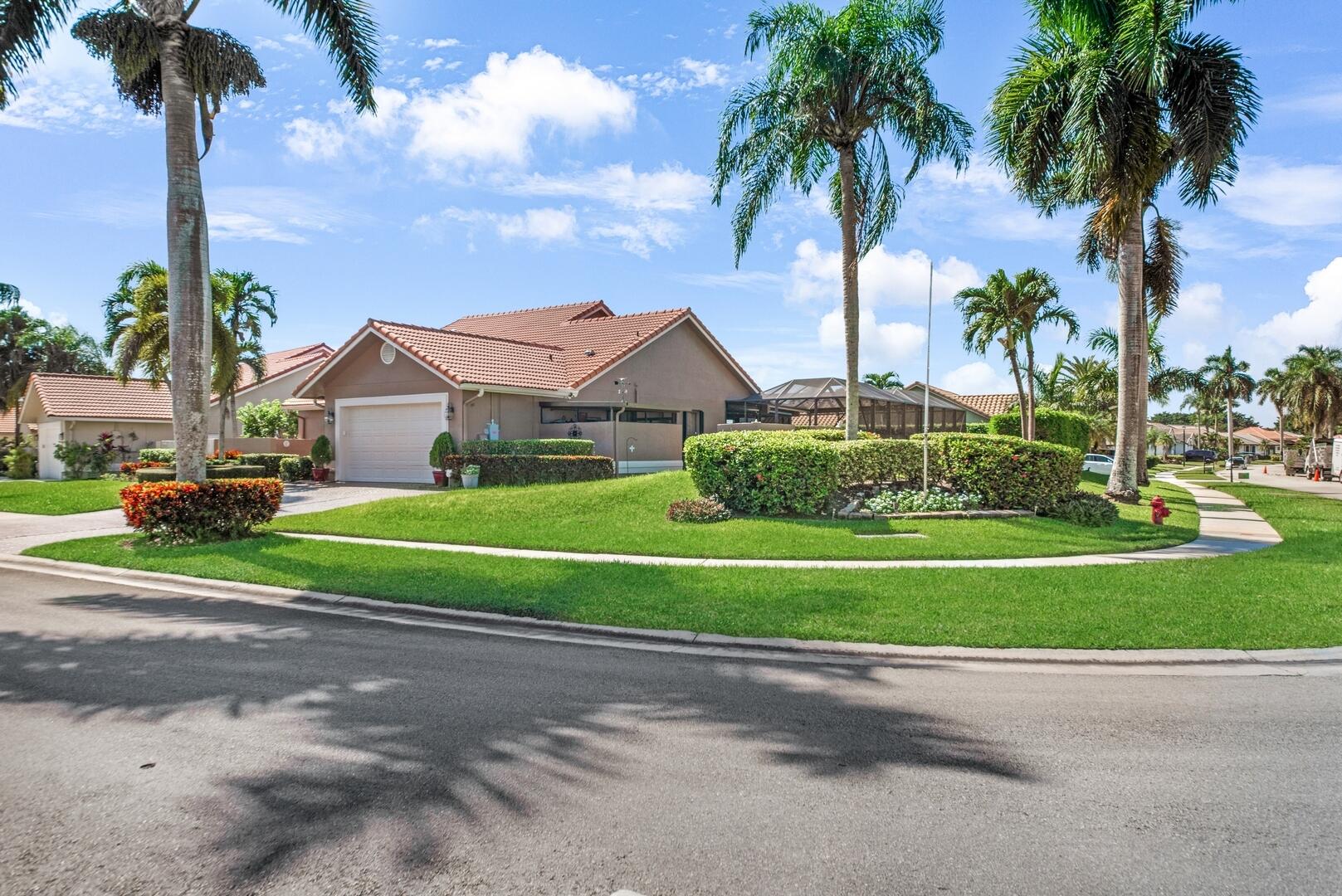 19261 Cherry Hills Terrace Boca Raton, FL 33498 - Photo 38 of 53 a front view of a house with garden and trees