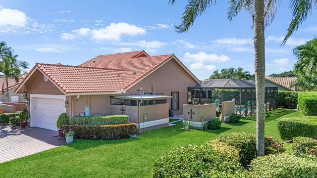 a front view of a house with a garden and plants
